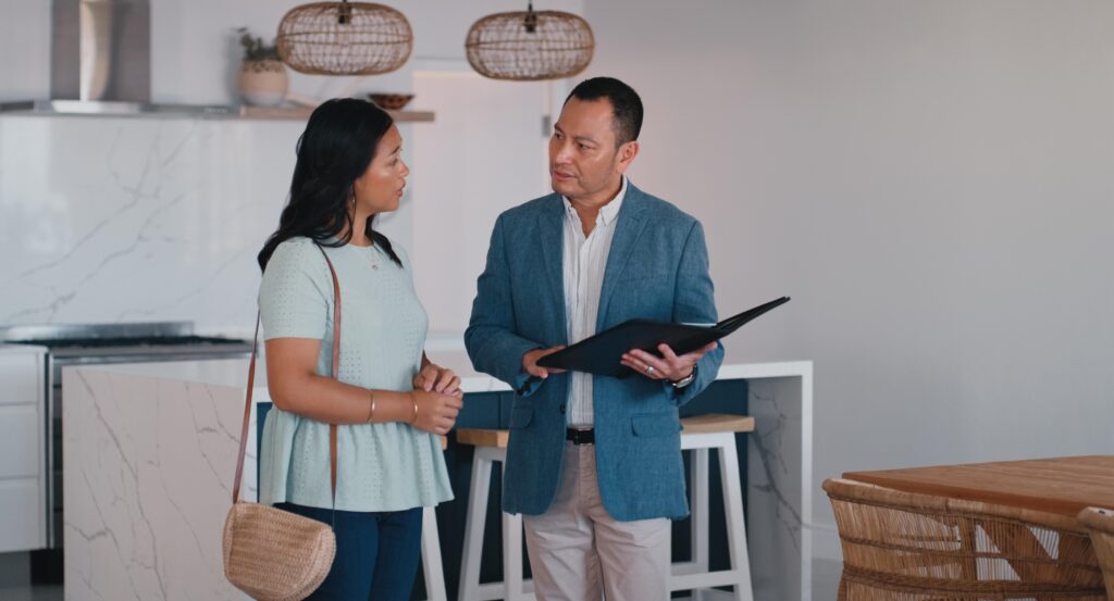 A home buyer asking a real estate agent questions before committing to them.